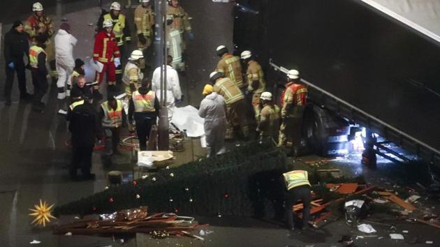 Rescuers and police investigators stand around a victim of a truck that ploughed through a crowd of a Christmas market on Breitscheidplatz square near the fashionable Kurfuerstendamm avenue in the west of Berlin, Germany on December 20. (REUTERS)