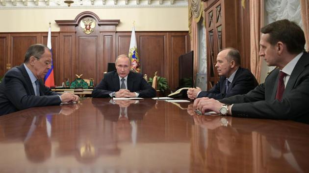 Russian President Vladimir Putin (2nd L) speaks with foreign minister Sergei Lavrov (L), director of the Foreign Intelligence Service (SVR) Sergei Naryshkin (R) and Alexander Bortnikov (2nd R), director of the Federal Security Service (FSB), during a meeting at the Kremlin in Moscow on December 19.(AFP)