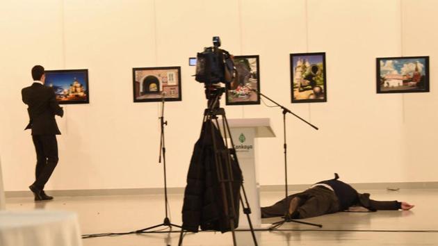 Russian Ambassador to Turkey Andrei Karlov lies on the ground after he was shot by unidentified man (L) at an art gallery in Ankara.(REUTERS)