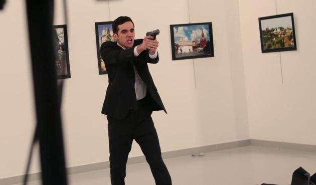 A gunman gestures after shooting the Russian ambassador to Turkey, Andrei Karlov, at a photo gallery in Ankara, Turkey, December 19(AP) A gunman gestures after shooting the Russian ambassador to Turkey, Andrei Karlov, at a photo gallery in Ankara, Turkey, December 19(AP)