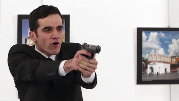A gunman points his gun, after shooting the Russian Ambassador to Turkey, Andrei Karlov, at a photo gallery in Ankara, Turkey.(AP Photo) A gunman points his gun, after shooting the Russian Ambassador to Turkey, Andrei Karlov, at a photo gallery in Ankara, Turkey.(AP Photo)