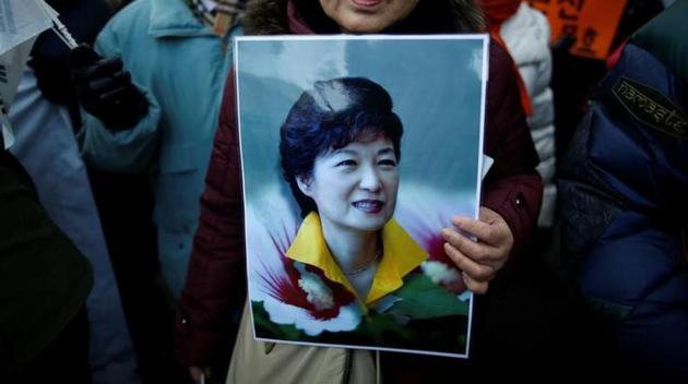 A supporter holds a portrait of South Korean President Park Geun-hye during a protest opposing her impeachment near the constitutional court in Seoul, South Korea. (Reuters) A supporter holds a portrait of South Korean President Park Geun-hye during a protest opposing her impeachment near the constitutional court in Seoul, South Korea. (Reuters)