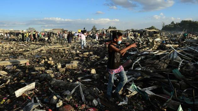 People search for goods and chattels amid the debris after the blast. (Ronaldo Schemidt/AFP)