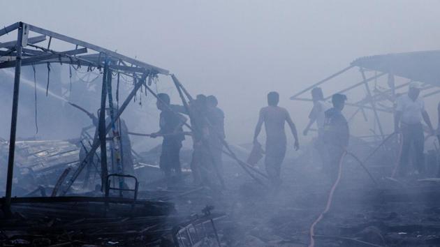 Rescuers and survivors work amid the smouldering ruins left after the blast. (Israel Gutiérrez R./AFP)