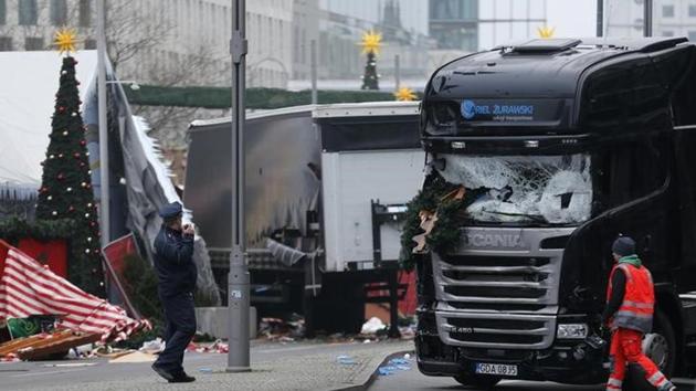 Police stand in front of the truck which ploughed last night into a crowded Christmas market in the German capital Berlin.(Reuters)