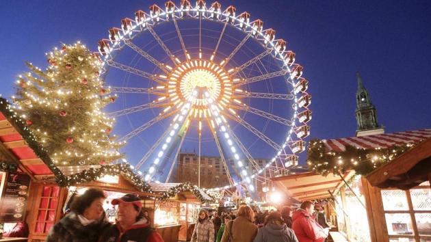 People walk around in the Christmas market near the city hall in Berlin on Wednesday. (AP photo)
