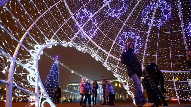 People walk into a giant illuminated Christmas ball at Oktyabrskaya Square in Minsk, Belarus. (Reuters photo)
