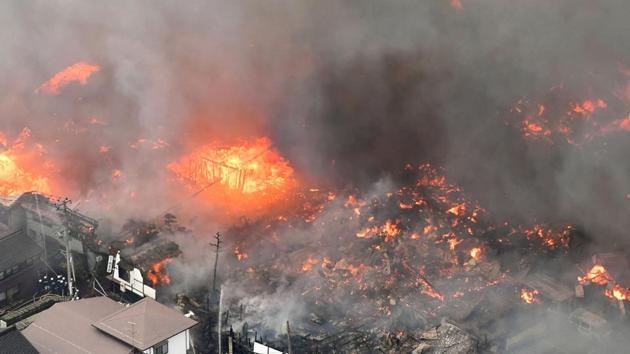 A fire engulfs houses and stores near JR Itoigawa Station in Itoigawa, Japan on Thursday.(Reuters photo) A fire engulfs houses and stores near JR Itoigawa Station in Itoigawa, Japan on Thursday.(Reuters photo)