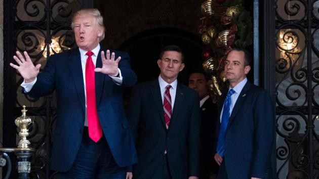 US President-elect Donald Trump (L) gestures as he speaks with Trump National Security Adviser Lt. General Michael Flynn (C) and Trump Chief of Staff Reince Priebus (R) at Mar-a-Lago in Palm Beach, Florida.(AFP Photo)