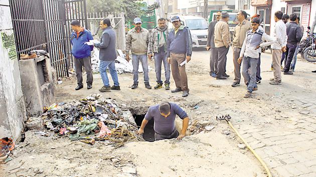 A B Ed degree holder, Buddhi Sagar, had to clean a manhole to get selected for the post of sanitation worker in Lucknow.(HT Photo) A B Ed degree holder, Buddhi Sagar, had to clean a manhole to get selected for the post of sanitation worker in Lucknow.(HT Photo)