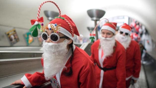Participants go up the escalator at Clapham Common Underground Station to take part in a charity ‘Santa Dash’, 5k and 10k runs, around Clapham Common in south London. (Justin TALLIS / AFP) Participants go up the escalator at Clapham Common Underground Station to take part in a charity ‘Santa Dash’, 5k and 10k runs, around Clapham Common in south London. (Justin TALLIS / AFP)