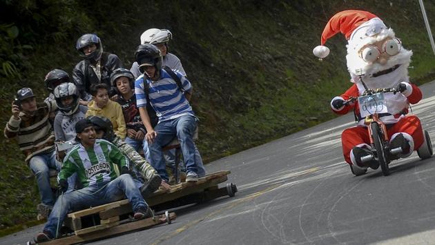 Participants fancy dressed go downhil in the XXVII Car Festival in a homemade cart in the Santa Elena Municipality, near Medellin, Antioquia department, Colombia. (RAUL ARBOLEDA / AFP) Participants fancy dressed go downhil in the XXVII Car Festival in a homemade cart in the Santa Elena Municipality, near Medellin, Antioquia department, Colombia. (RAUL ARBOLEDA / AFP)