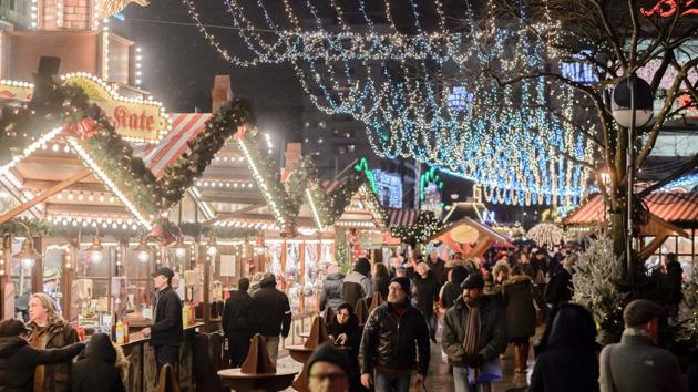People walk at the Christmas market near the Kaiser-Wilhelm-Gedaechtniskirche (Kaiser Wilhelm Memorial Church) in Berlin on December 22, 2016. The Berlin Christmas market that was struck by a deadly truck rampage on December 19, 2016 reopened, as the grieving city sought a return to normal life and police hunted for the prime suspect in the attack.(AFP Photo) People walk at the Christmas market near the Kaiser-Wilhelm-Gedaechtniskirche (Kaiser Wilhelm Memorial Church) in Berlin on December 22, 2016. The Berlin Christmas market that was struck by a deadly truck rampage on December 19, 2016 reopened, as the grieving city sought a return to normal life and police hunted for the prime suspect in the attack.(AFP Photo)