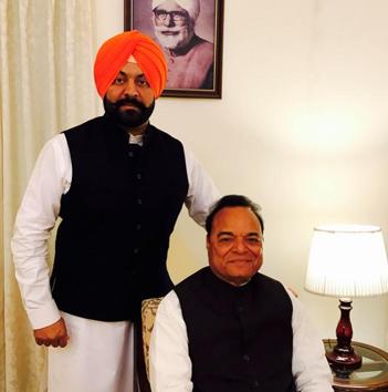 Jalandhar MP Chaudhary Santokh Singh, youngest son of Master Gurbanta Singh (seen in the wall portrait); along with his son Vikaramjit Chaudhary.(HT Photo)