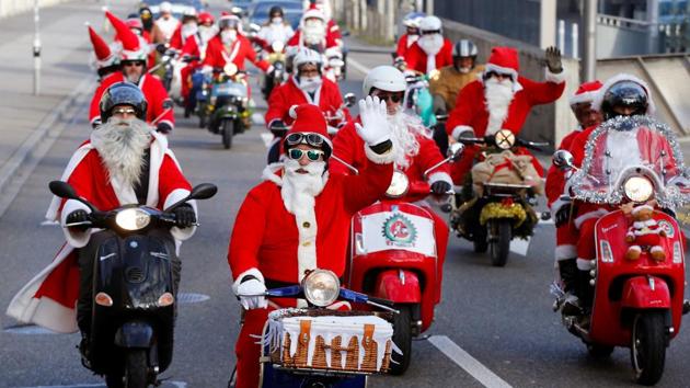 Members of a Vespa Fan Club dressed as Santa Claus (Samichlaus) ride on their scooters in Zurich, Switzerland . (Arnd Wiegmann / REUTERS) Members of a Vespa Fan Club dressed as Santa Claus (Samichlaus) ride on their scooters in Zurich, Switzerland . (Arnd Wiegmann / REUTERS)