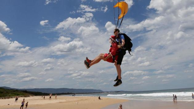 Tandem skydivers Sebastian Terry (in Santa suit) and Luke Biggs land on a beach as 155 tandem skydives breaks the Guinness World Record number of tandem skydivers over eight hours in the Australian city of Wollongong. (Jason Reed / REUTERS) Tandem skydivers Sebastian Terry (in Santa suit) and Luke Biggs land on a beach as 155 tandem skydives breaks the Guinness World Record number of tandem skydivers over eight hours in the Australian city of Wollongong. (Jason Reed / REUTERS)