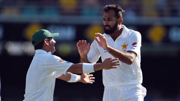 Pakistan's paceman Wahab Riaz (R) celebrates his wicket of Australia's batsman Matt Renshaw during the first day-night cricket Test against Australia.(AFP)