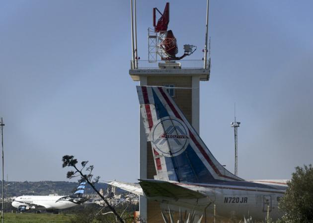 An Afriqiyah Airways plane from Libya, left, stands on the tarmac at Malta's Luqa International airport. (AP Photo)