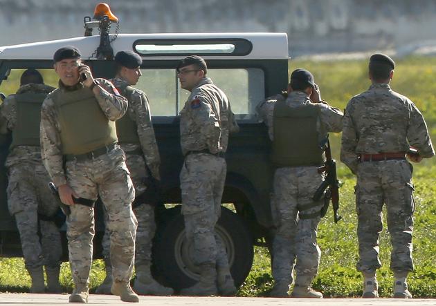 Maltese troops survey a hijacked Libyan Afriqiyah Airways Airbus A320 on the runway at Malta Airport. (REUTERS)