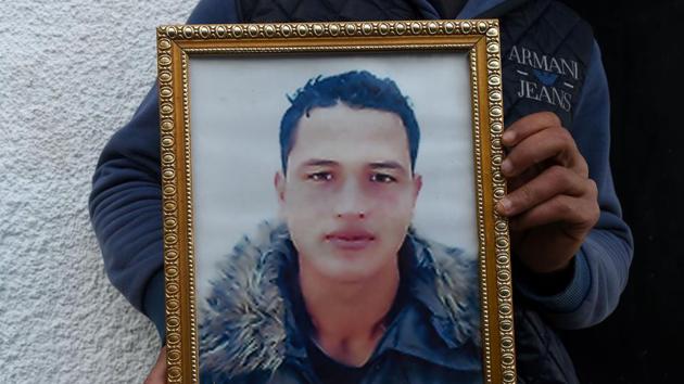 A relative of 24-year-old Anis Amri, the prime suspect in Berlin's deadly truck attack, poses with his portrait in front of the family house in the town of Oueslatia, in Tunisia's region of Kairouan on December 23, 2016. (AFP) A relative of 24-year-old Anis Amri, the prime suspect in Berlin's deadly truck attack, poses with his portrait in front of the family house in the town of Oueslatia, in Tunisia's region of Kairouan on December 23, 2016. (AFP)