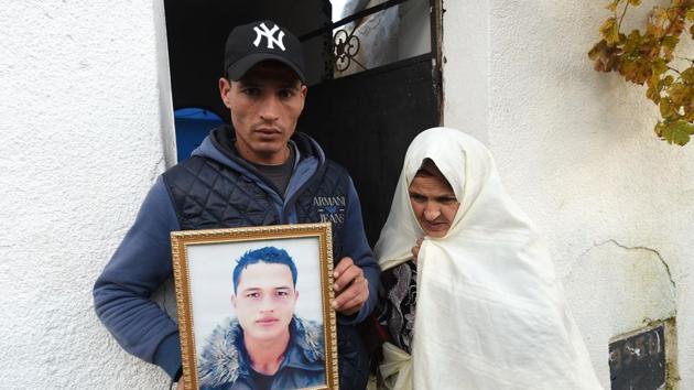 Walid Amri (L), the brother of 24-year-old Anis Amri, the prime suspect in Berlin's deadly truck attack, poses with a portrait of his brother in front of the family house in the town of Oueslatia, in Tunisia's region of Kairouan.(AFP Photo) Walid Amri (L), the brother of 24-year-old Anis Amri, the prime suspect in Berlin's deadly truck attack, poses with a portrait of his brother in front of the family house in the town of Oueslatia, in Tunisia's region of Kairouan.(AFP Photo)