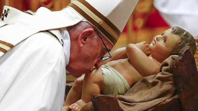 Pope Francis kisses a statue of baby Jesus at the end of the Christmas night Mass in Saint Peter's Basilica at the Vatican on Christmas eve. (Reuters) Pope Francis kisses a statue of baby Jesus at the end of the Christmas night Mass in Saint Peter's Basilica at the Vatican on Christmas eve. (Reuters)