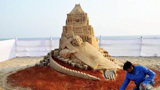 Sand artist Manas Sahoo creates a sand sculpture celebrating Christmas at the beach at Puri in Odisha. (PTI Photo) Sand artist Manas Sahoo creates a sand sculpture celebrating Christmas at the beach at Puri in Odisha. (PTI Photo)