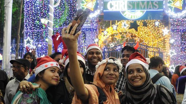 A group of young people take a selfie during Christmas Eve celebration before mid-night mass prayer at Park Street in Kolkata. (Samir Jana/HT Photo) A group of young people take a selfie during Christmas Eve celebration before mid-night mass prayer at Park Street in Kolkata. (Samir Jana/HT Photo)