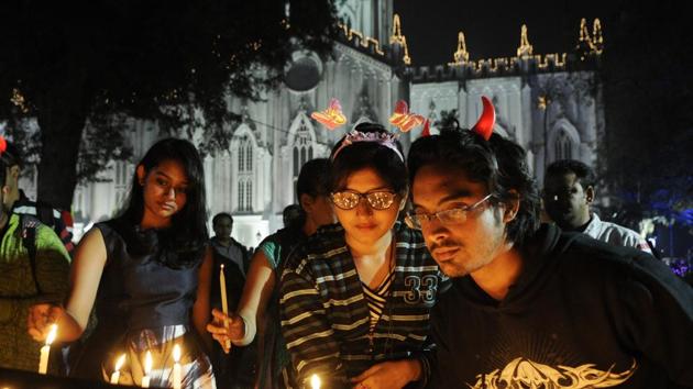 People lighting candles during Christmas Eve celebrations in front of St. Paul's Cathedral before Midnight Mass in Kolkata. (Samir Jana/HT Photo) People lighting candles during Christmas Eve celebrations in front of St. Paul's Cathedral before Midnight Mass in Kolkata. (Samir Jana/HT Photo)