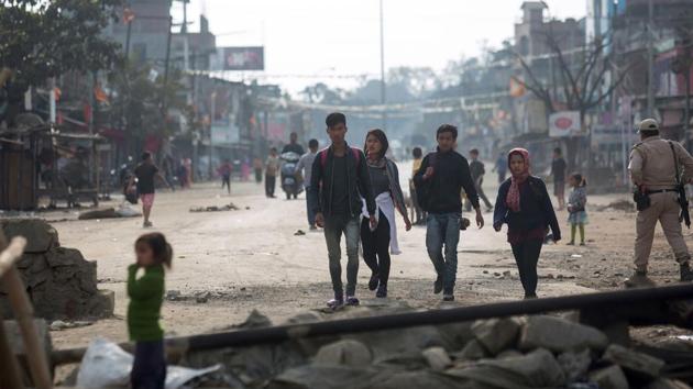 Pedestrians walk past temporary roadblocks on the outskirts of Imphal on December 20, 2016.(AFP File Photo) Pedestrians walk past temporary roadblocks on the outskirts of Imphal on December 20, 2016.(AFP File Photo)