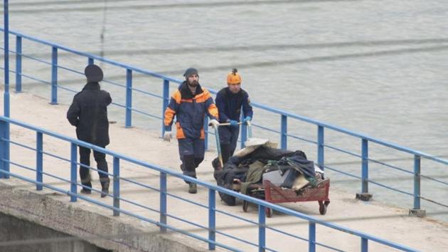 At a quay in the Sochi suburb of Khosta, Russian emergencies ministry members push a cart with remains of Russian military Tu-154 plane which crashed into the Black Sea on Sunday. (Reuters) At a quay in the Sochi suburb of Khosta, Russian emergencies ministry members push a cart with remains of Russian military Tu-154 plane which crashed into the Black Sea on Sunday. (Reuters)