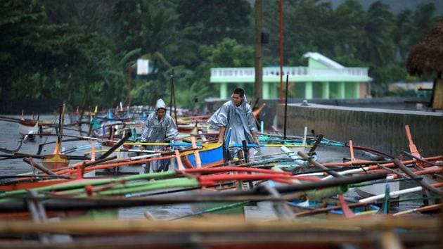 Fishermen secure their boats in the bay of Santo Domingo, Albay province as typhoon Nock-Ten approached.(AFP Photo) Fishermen secure their boats in the bay of Santo Domingo, Albay province as typhoon Nock-Ten approached.(AFP Photo)