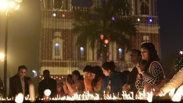 Devotees lights the candles at the Sacred Heart Cathedral on Christmas Eve in New Delhi. (Vipin Kumar/HT Photo) Devotees lights the candles at the Sacred Heart Cathedral on Christmas Eve in New Delhi. (Vipin Kumar/HT Photo)