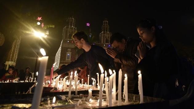 Devotees lights the candles at the Sacred Heart Cathedral on Christmas Eve in New Delhi. (Vipin Kumar/HT Photo) Devotees lights the candles at the Sacred Heart Cathedral on Christmas Eve in New Delhi. (Vipin Kumar/HT Photo)
