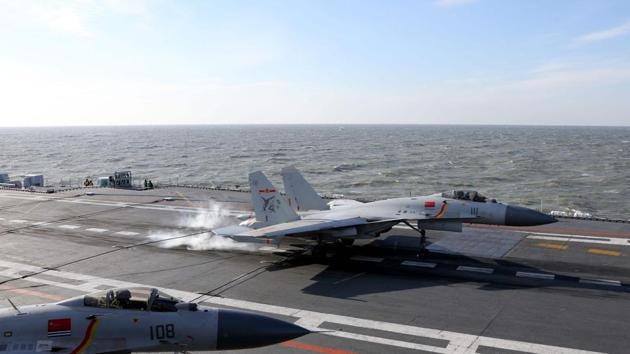 A Chinese J-15 fighter jet lands on the deck of the Liaoning aircraft carrier during military drills in the Bohai Sea, off China's northeast coast.(AFP) A Chinese J-15 fighter jet lands on the deck of the Liaoning aircraft carrier during military drills in the Bohai Sea, off China's northeast coast.(AFP)
