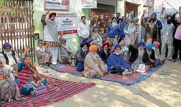 Customers protesting outside Punjab National Bank branch at Dhandra village on Monday.(JS Grewal/HT) Customers protesting outside Punjab National Bank branch at Dhandra village on Monday.(JS Grewal/HT)