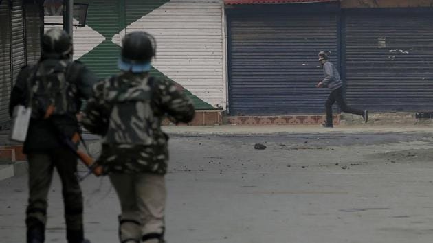 Soldiers chase a protester during a protest after Friday prayers in Srinagar. (AP Photo) Soldiers chase a protester during a protest after Friday prayers in Srinagar. (AP Photo)