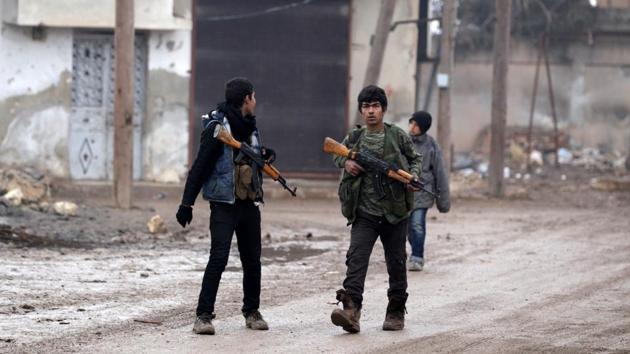Youth carry weapons along a road in al-Rai town, northern Aleppo countryside, Syria. (Reuters Photo) Youth carry weapons along a road in al-Rai town, northern Aleppo countryside, Syria. (Reuters Photo)