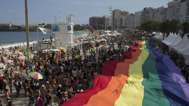 People carry a giant gay movement flag during the Gay Pride Parade at Copacabana beach in Rio de Janeiro, Brazil. (AP) People carry a giant gay movement flag during the Gay Pride Parade at Copacabana beach in Rio de Janeiro, Brazil. (AP)