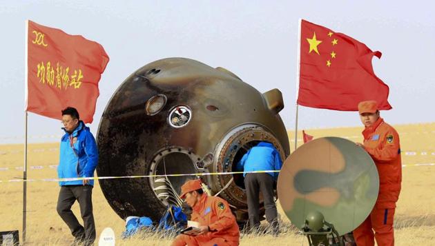 In this Nov. 18, 2016 file photo released, ground crew check on the re-entry capsule of Shenzhou 11 spacecraft, which brought back a pair of Chinese astronauts from a monthlong stay aboard China's space station, after it landed in north China's Inner Mongolia Autonomous Region.(AP) In this Nov. 18, 2016 file photo released, ground crew check on the re-entry capsule of Shenzhou 11 spacecraft, which brought back a pair of Chinese astronauts from a monthlong stay aboard China's space station, after it landed in north China's Inner Mongolia Autonomous Region.(AP)