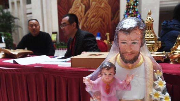 A religious figurine is seen at a check-in desk for the ninth Chinese Catholic representative conference in Beijing.(AFP Photo) A religious figurine is seen at a check-in desk for the ninth Chinese Catholic representative conference in Beijing.(AFP Photo)