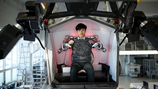 An employee sits inside the control room of the manned biped walking robot Method-2 during a demonstration. It is claimed as a world-first by its creators at Hankook Mirae Technology, a South Korean robotics company, where about 30 engineers were hard at work conducting initial tests Tuesday afternoon. (REUTERS)