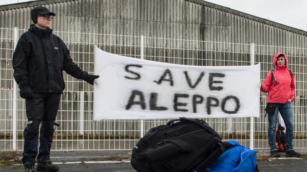 Participants of the solidarity march to Aleppo hold a banner reading "Save Aleppo" in Berlin, Germany, on December 26, 2016.(AFP Photo) Participants of the solidarity march to Aleppo hold a banner reading "Save Aleppo" in Berlin, Germany, on December 26, 2016.(AFP Photo)