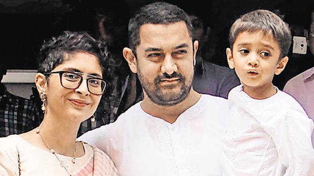 Bollywood actor Aamir Khan, (C), with his wife, director Kiran Rao and son Azad celebrates at their residence in Mumbai.(AFP File Photo)