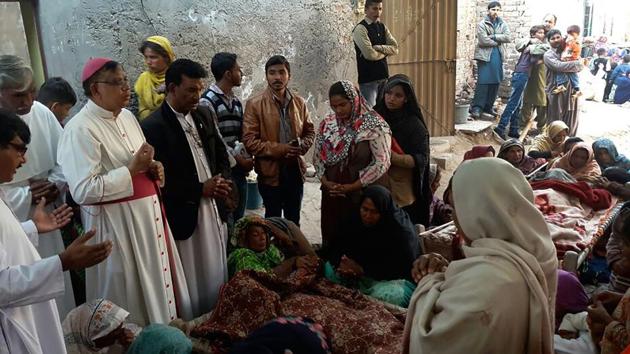 Pakistani Christians mourn the death of relatives killed by toxic liquor on Christmas Eve in a colony at Toba Tek Singh, 338 kilometres km south of Islamabad, on December 27. Thirty people, mostly Christians, were killed and dozens more fell sick after drinking toxic liquor at a party, police said, the latest case of deadly alcohol poisoning in the Muslim country.(AFP)