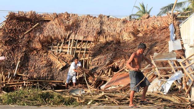 Residents work on their damaged house after strong winds brought by Typhoon Nock-ten battered Camarines Sur. (Romeo Ranoco/REUTERS)