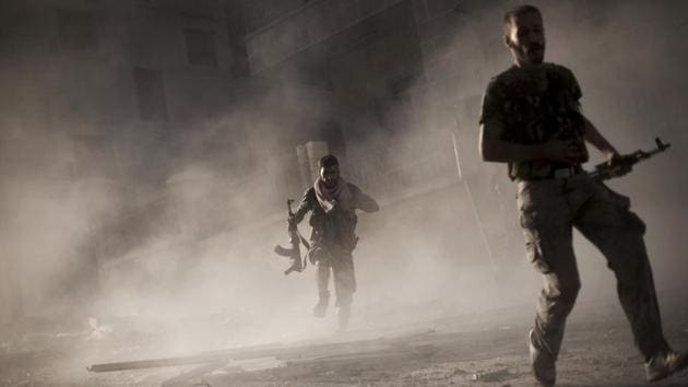 Free Syrian Army fighters run away after attacking a Syrian Army tank during fighting in the Izaa district in Aleppo.(AP Photo) Free Syrian Army fighters run away after attacking a Syrian Army tank during fighting in the Izaa district in Aleppo.(AP Photo)