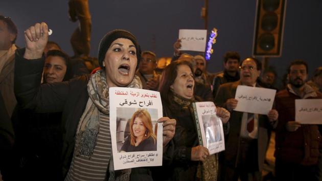Protesters chant slogans demanding the release of kidnapped journalist Afrah Shawqi al-Qaisi, seen in posters, during a demonstration, in Baghdad. Late Monday night unidentified gunmen broke into the house of al-Qaisi, a journalist and activist in Baghdad and kidnapped her.(AP Photo) Protesters chant slogans demanding the release of kidnapped journalist Afrah Shawqi al-Qaisi, seen in posters, during a demonstration, in Baghdad. Late Monday night unidentified gunmen broke into the house of al-Qaisi, a journalist and activist in Baghdad and kidnapped her.(AP Photo)
