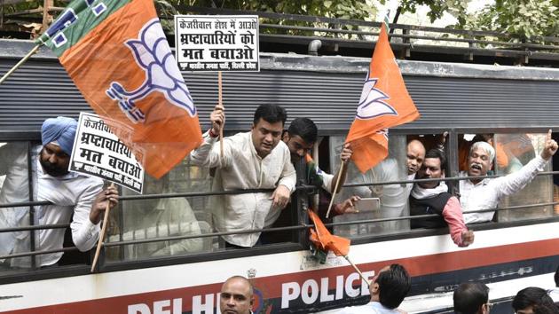 BJP workers being detained as they protest against Delhi CM Arvind Kejriwal during the special session of Vidhan Sabha on black money in New Delhi.(Mohd Zakir/HT PHOTO)