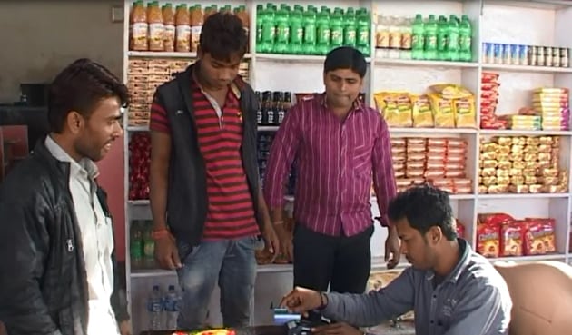 A resident swipes to pay at a grocery shop in Palakhede village in Agar district on Wednesday. (HT photo) A resident swipes to pay at a grocery shop in Palakhede village in Agar district on Wednesday. (HT photo)